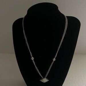 JOAN Boyce evil eye necklace.